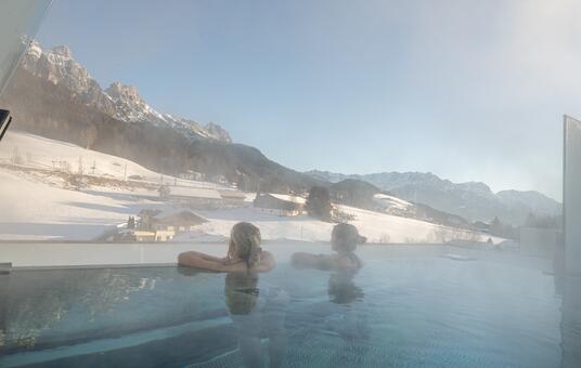 Two women in the infinity pool in winter.