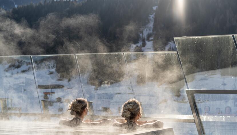 Two women in the infinity pool in winter.
